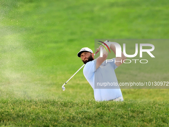 Jon Rahm of Barrika, Spain hits from a bunker on the 18th fairway during The Memorial Tournament presented by Workday at Muirfield Village G...