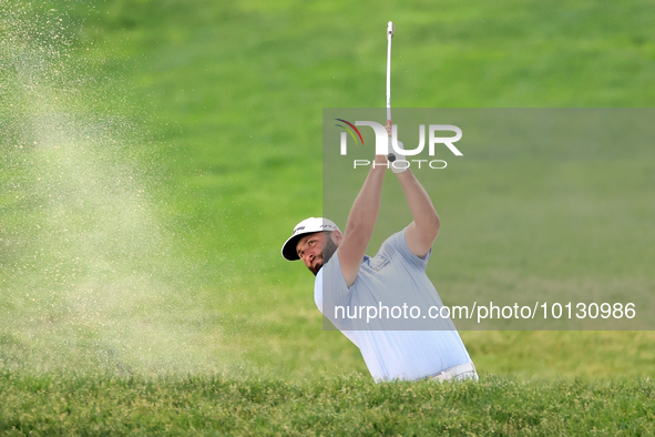 Jon Rahm of Barrika, Spain hits from a bunker on the 18th fairway during The Memorial Tournament presented by Workday at Muirfield Village G...