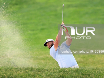 Jon Rahm of Barrika, Spain hits from a bunker on the 18th fairway during The Memorial Tournament presented by Workday at Muirfield Village G...