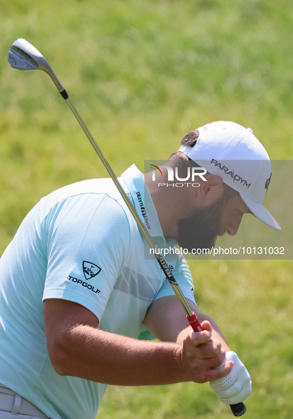 John Rahm of Barrika, Spain chips onto the 7th green with Jason Day of Brisbane, Australia during The Memorial Tournament presented by Workd...