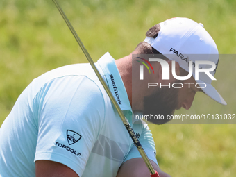 John Rahm of Barrika, Spain chips onto the 7th green with Jason Day of Brisbane, Australia during The Memorial Tournament presented by Workd...