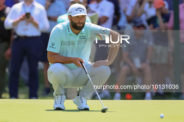 John Rahm of Barrika, Spain lines up his putt on the 7th green with Jason Day of Brisbane, Australia during The Memorial Tournament presente...