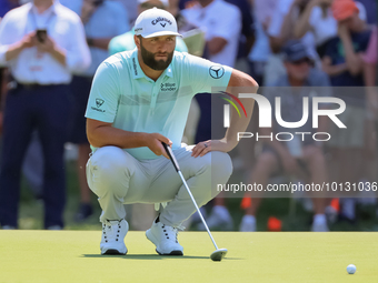 John Rahm of Barrika, Spain lines up his putt on the 7th green with Jason Day of Brisbane, Australia during The Memorial Tournament presente...