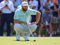 John Rahm of Barrika, Spain lines up his putt on the 7th green with Jason Day of Brisbane, Australia during The Memorial Tournament presente...