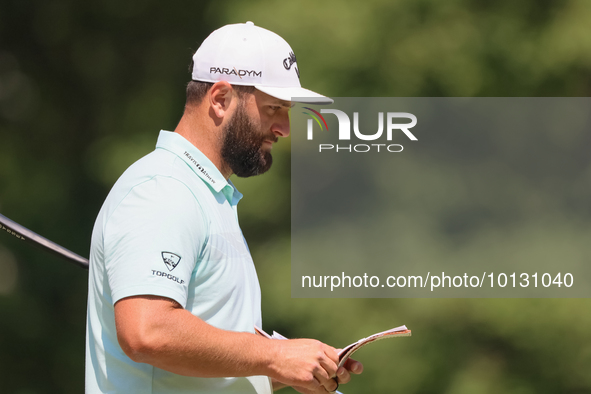 John Rahm of Barrika, Spain looks over the 8th green with Jason Day of Brisbane, Australia during The Memorial Tournament presented by Workd...