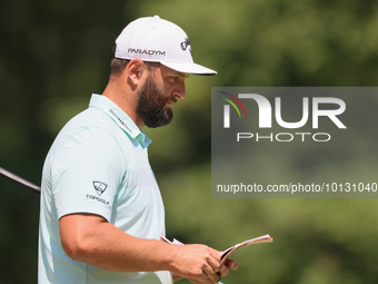 John Rahm of Barrika, Spain looks over the 8th green with Jason Day of Brisbane, Australia during The Memorial Tournament presented by Workd...