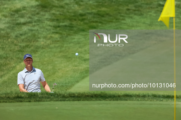 Cam Davis of Sydney, Australia follows his shot toward the 18th green  from the bunker during the first round of the The Memorial Tournament...