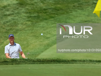 Cam Davis of Sydney, Australia follows his shot toward the 18th green  from the bunker during the first round of the The Memorial Tournament...