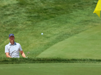 Cam Davis of Sydney, Australia follows his shot toward the 18th green  from the bunker during the first round of the The Memorial Tournament...