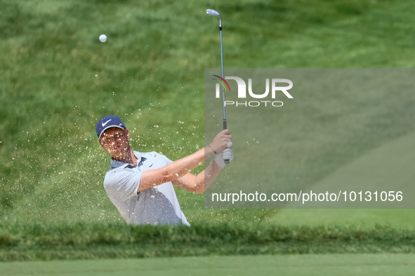 Cam Davis of Sydney, Australia follows his shot toward the 18th green  from the bunker during the first round of the The Memorial Tournament...