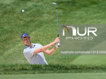 Cam Davis of Sydney, Australia follows his shot toward the 18th green  from the bunker during the first round of the The Memorial Tournament...