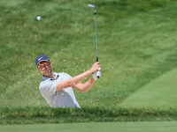 Cam Davis of Sydney, Australia follows his shot toward the 18th green  from the bunker during the first round of the The Memorial Tournament...