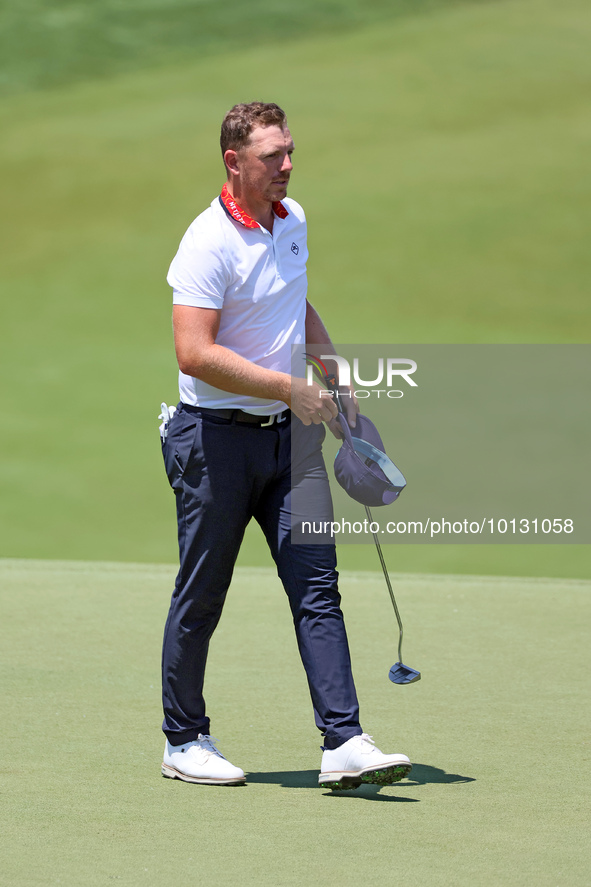 Matt Wallace of England walks on the 18th green after completing the first round of the The Memorial Tournament presented by Workday at Muir...