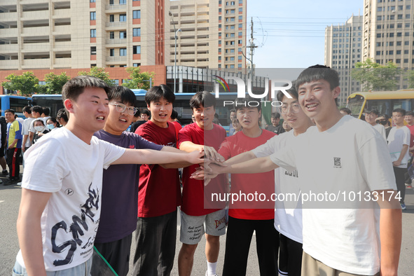  Students cheer for themselves at a college entrance examination site in Lianyungang, Jiangsu province, China, on June 7, 2023. 