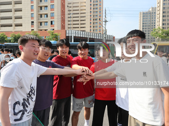  Students cheer for themselves at a college entrance examination site in Lianyungang, Jiangsu province, China, on June 7, 2023. (