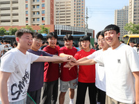  Students cheer for themselves at a college entrance examination site in Lianyungang, Jiangsu province, China, on June 7, 2023. (