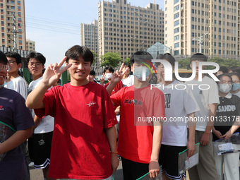  Students cheer for themselves at a college entrance examination site in Lianyungang, Jiangsu province, China, on June 7, 2023. (