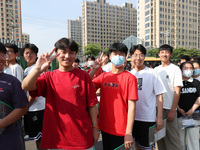  Students cheer for themselves at a college entrance examination site in Lianyungang, Jiangsu province, China, on June 7, 2023. (