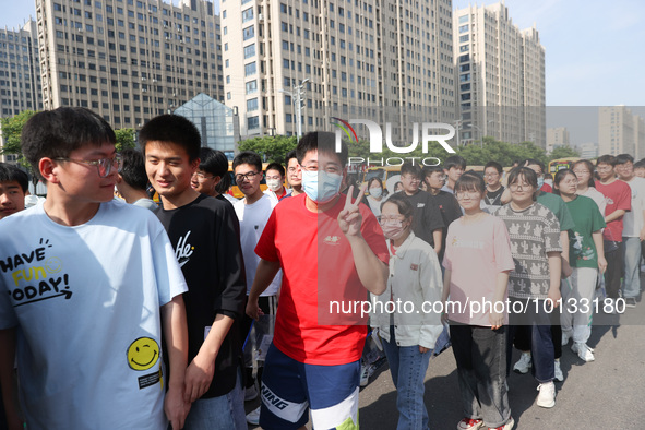  Students cheer for themselves at a college entrance examination site in Lianyungang, Jiangsu province, China, on June 7, 2023. 