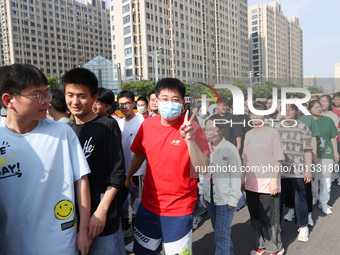  Students cheer for themselves at a college entrance examination site in Lianyungang, Jiangsu province, China, on June 7, 2023. (