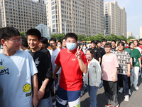  Students cheer for themselves at a college entrance examination site in Lianyungang, Jiangsu province, China, on June 7, 2023. (