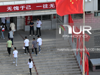  Students enter a national college entrance examination center in Bazhou, Xinjiang province, China, on June 7, 2023. (