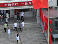  Students enter a national college entrance examination center in Bazhou, Xinjiang province, China, on June 7, 2023. (