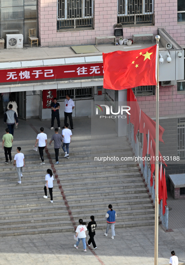  Students enter a national college entrance examination center in Bazhou, Xinjiang province, China, on June 7, 2023. 