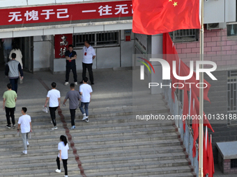  Students enter a national college entrance examination center in Bazhou, Xinjiang province, China, on June 7, 2023. (