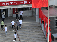  Students enter a national college entrance examination center in Bazhou, Xinjiang province, China, on June 7, 2023. (