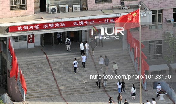  Students enter a national college entrance examination center in Bazhou, Xinjiang province, China, on June 7, 2023. 