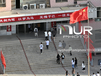  Students enter a national college entrance examination center in Bazhou, Xinjiang province, China, on June 7, 2023. (