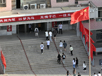  Students enter a national college entrance examination center in Bazhou, Xinjiang province, China, on June 7, 2023. (