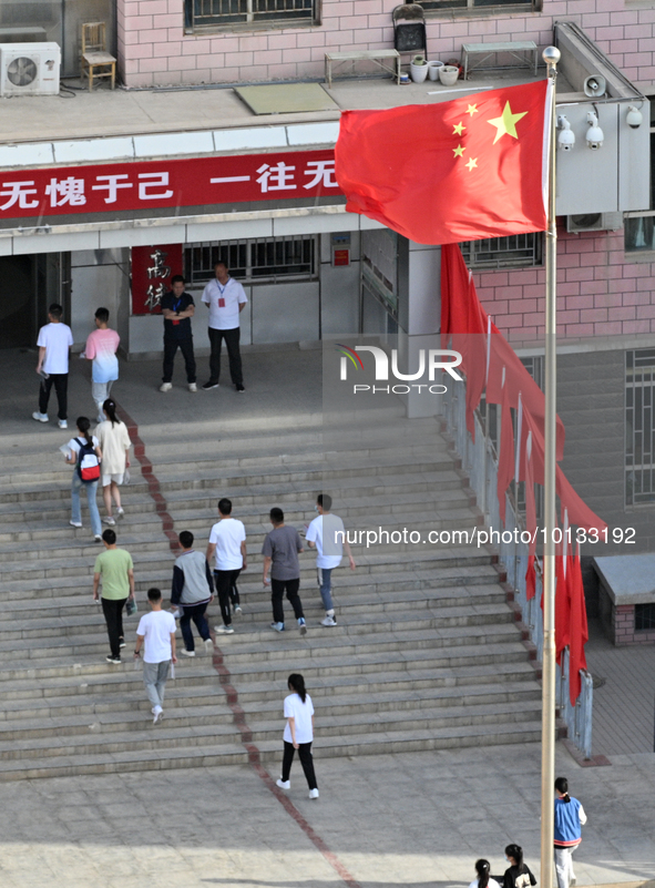  Students enter a national college entrance examination center in Bazhou, Xinjiang province, China, on June 7, 2023. 