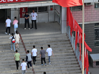  Students enter a national college entrance examination center in Bazhou, Xinjiang province, China, on June 7, 2023. (