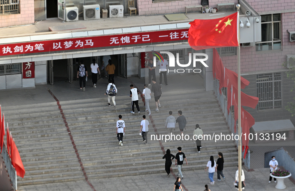  Students enter a national college entrance examination center in Bazhou, Xinjiang province, China, on June 7, 2023. 