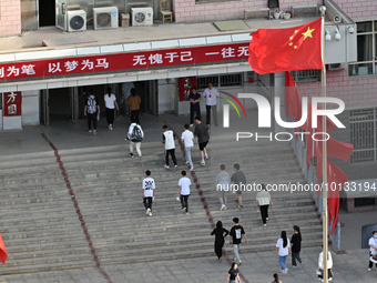  Students enter a national college entrance examination center in Bazhou, Xinjiang province, China, on June 7, 2023. (