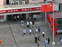  Students enter a national college entrance examination center in Bazhou, Xinjiang province, China, on June 7, 2023. (