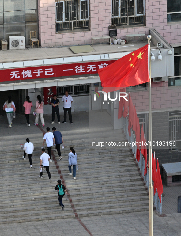  Students enter a national college entrance examination center in Bazhou, Xinjiang province, China, on June 7, 2023. 