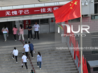  Students enter a national college entrance examination center in Bazhou, Xinjiang province, China, on June 7, 2023. (