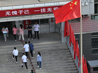  Students enter a national college entrance examination center in Bazhou, Xinjiang province, China, on June 7, 2023. (