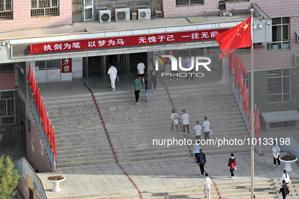  Students enter a national college entrance examination center in Bazhou, Xinjiang province, China, on June 7, 2023. 