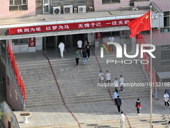  Students enter a national college entrance examination center in Bazhou, Xinjiang province, China, on June 7, 2023. (