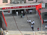  Students enter a national college entrance examination center in Bazhou, Xinjiang province, China, on June 7, 2023. (