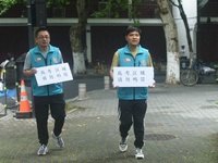 HANGZHOU, CHINA - JUNE 7, 2023 - Volunteers remind vehicles not to sound their horns near a test center for the National College entrance ex...