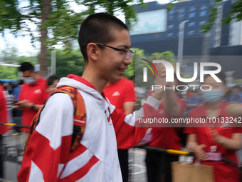 Candidates walk into the entrance examination center of the High School Affiliated to Beijing People's Congress for the National College Ent...