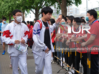 Candidates walk into the entrance examination center of the High School Affiliated to Beijing People's Congress for the National College Ent...