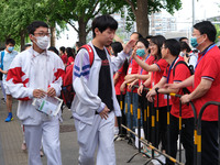 Candidates walk into the entrance examination center of the High School Affiliated to Beijing People's Congress for the National College Ent...