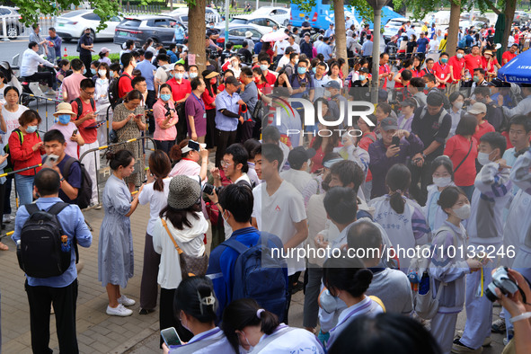 Candidates walk into the entrance examination center of the High School Affiliated to Beijing People's Congress for the National College Ent...