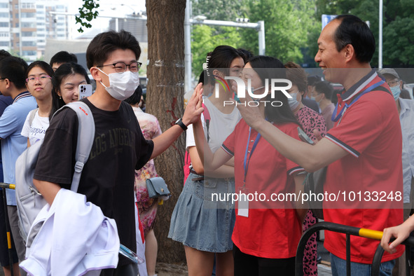 Candidates walk into the entrance examination center of the High School Affiliated to Beijing People's Congress for the National College Ent...